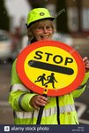 lollypop-lady-holding-a-stop-sign-board-and-smiling-london-england-B0TEA8.jpg